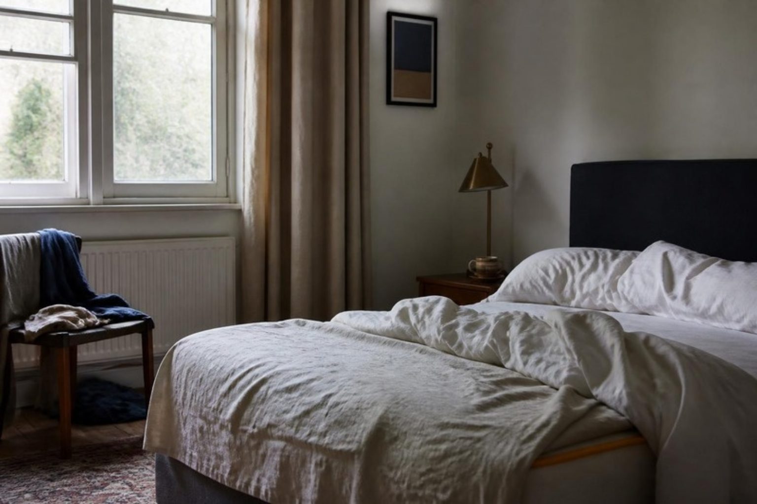 A real bedroom with a Chapter mattress, the tape edge just showing under the duvet